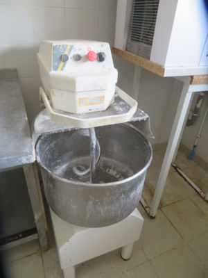 a mixer that is sitting on a stand in a kitchen