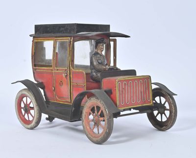 a small toy car with a man in the driver ' s seat