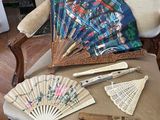 a chair that has a fan, a knife, and other items on it