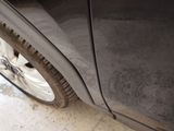 a close up of a black car with a flat tire