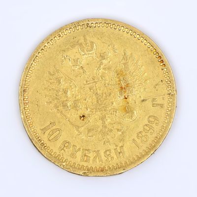 une vieille pièce d'or sur une surface blanche avec un fond blanc