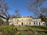 an image of a large house with a lot of trees in front of it