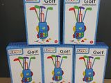 four boxes of golf equipment sitting on top of a wooden table