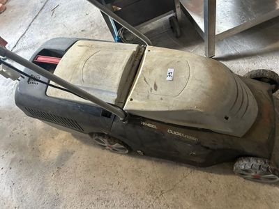 a lawn mower that is sitting on the ground