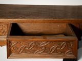 a wooden desk with a drawer on top of it
