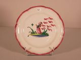 a plate with a picture of a bird and flowers on it