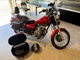 a red motorcycle that is parked in a showroom