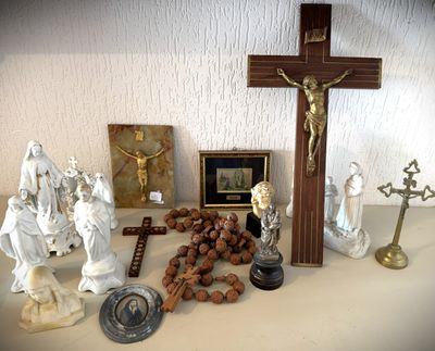 a cross, figurines, and other religious items on a table