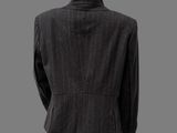 the back view of a mannequin suit with a black jacket and black pants