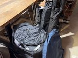 a table with a guitar case on it and a bag on the table