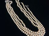a three strand pearl necklace and earring set