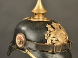 a black helmet with a gold decoration on it