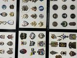 several framed pictures of various badges and pins on a carpet