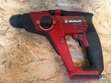 an electric drill is laying on a wooden surface