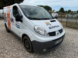 a white van that is parked in the gravel
