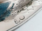 a close up of a knife on a white surface