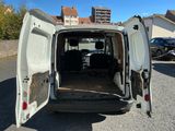 une camionnette blanche dont les portes sont ouvertes, garée sur un parking