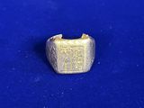 a close up of a gold ring on a blue surface