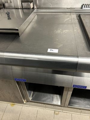 stainless steel counter top in a commercial kitchen with a lot of counter space