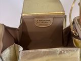 gold leather handbag with a gold handle and a matching purse