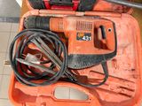 an orange tool case with tools in it on a tile floor