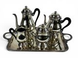 a silver tray with a silver tea set on it
