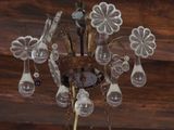 a chandelier hanging from the ceiling with several lamps on it