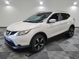 a white nissan suv parked on a checkered floor in a garage