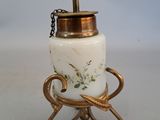 a white and gold vase with a chain on it