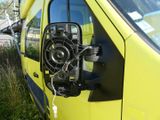 a yellow van with a fan attached to the side of it