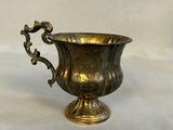 a silver cup that is sitting on a table