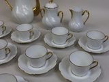 a lot of cups and saucers sitting on a table