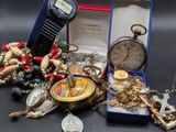 a box with a bunch of jewelry and a pocket watch