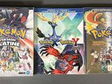 Trois jeux vidéo Pokémon sont exposés sur une table
