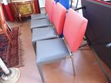 four chairs that are lined up in a row