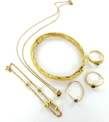 an image of a collection of gold jewelry on a white surface