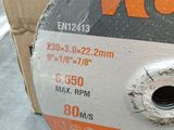 a close up of a metal disc on a table