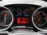 a close up of a car dashboard with various gauges