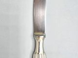 a knife that is sitting on a white surface