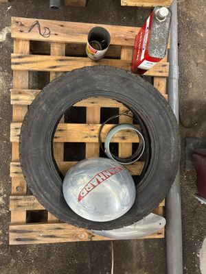a tire that is sitting on a pallet next to some tools
