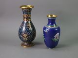 two vases sitting next to each other on a table