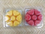 two plastic containers with heart shaped candies in them