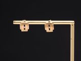 a close up of a pair of gold earrings on a black background
