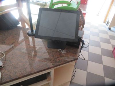 a laptop computer sitting on top of a kitchen counter