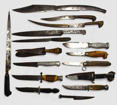 many different types of knives on a white surface