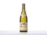 a bottle of white wine sitting on top of a table