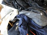a pile of clothes sitting on top of a pile of luggage