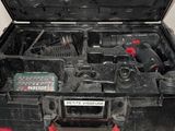 a black tool box with tools in it on a table