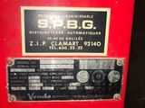a close up of a red machine with a sign on it