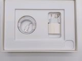 a white box with a charger and a cable in it